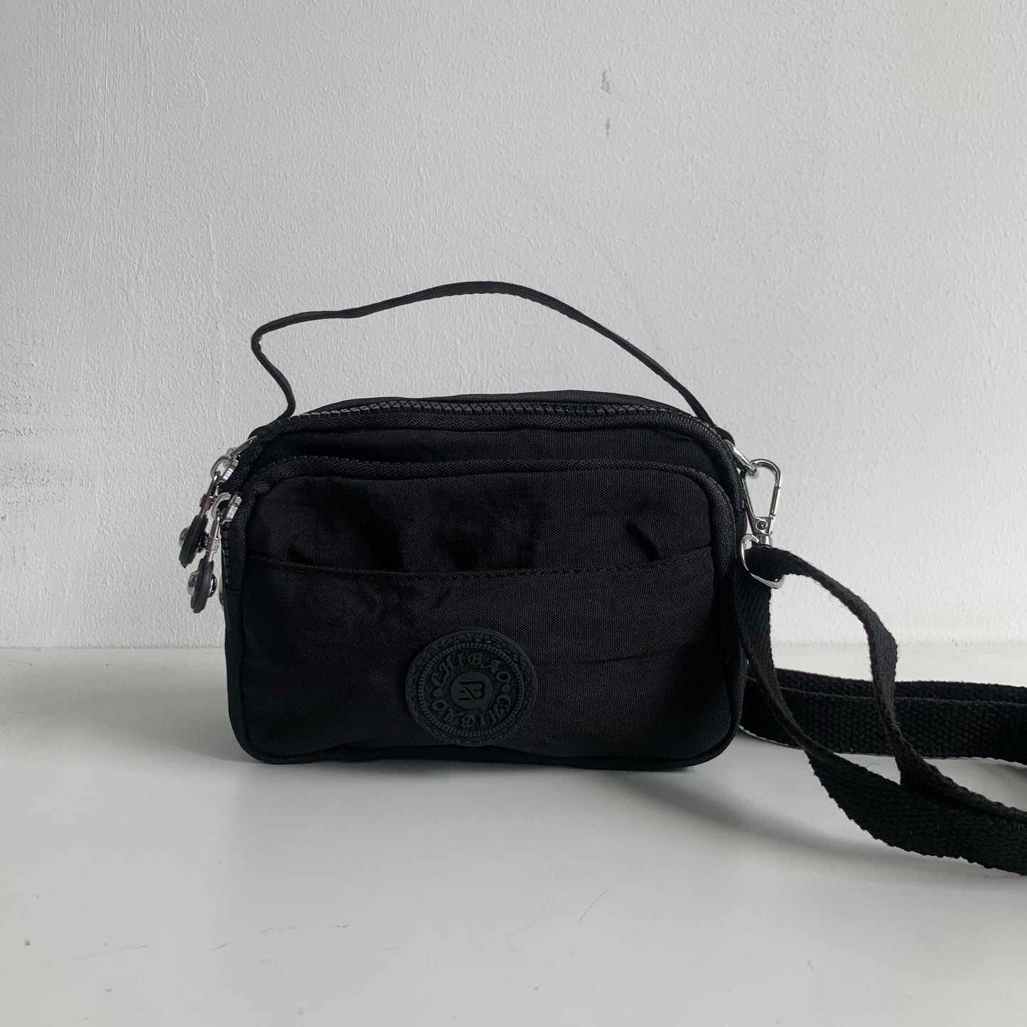 GESSY SMALL WATERPROOF UNISEX TOP HANDLE NYLON CROSSBODY BAG IN BLACK