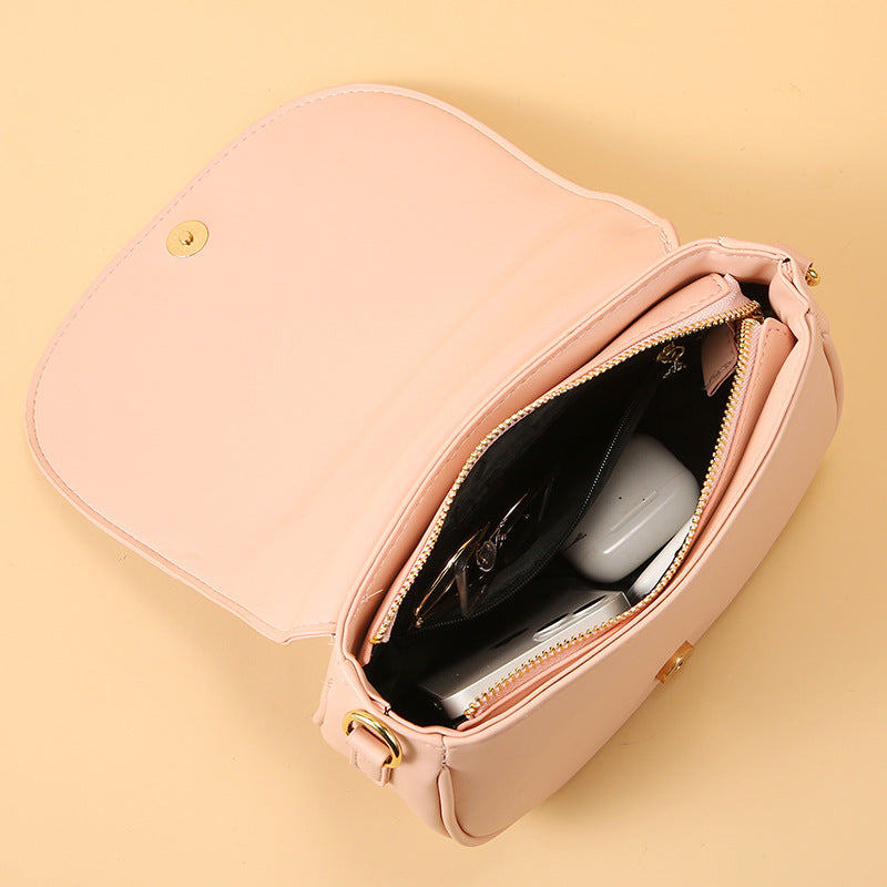 GESSY OVAL SHAPED CROSSBODY FLAP BAG IN BLACK