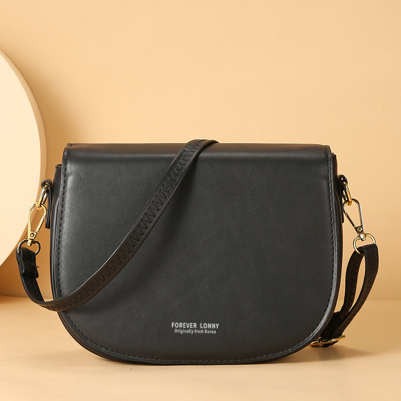 GESSY OVAL SHAPED CROSSBODY FLAP BAG IN BLACK