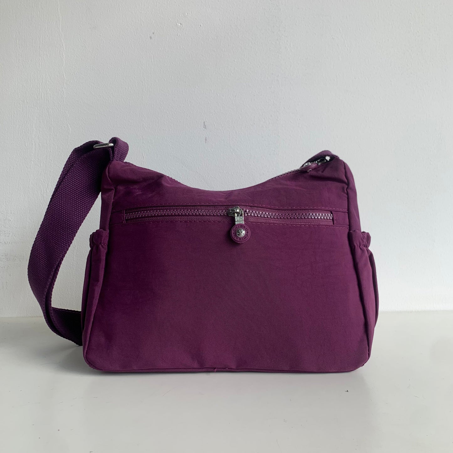 GESSY FRONT TRIPLE ZIP NYLON CROSSBODY BAG IN PURPLE