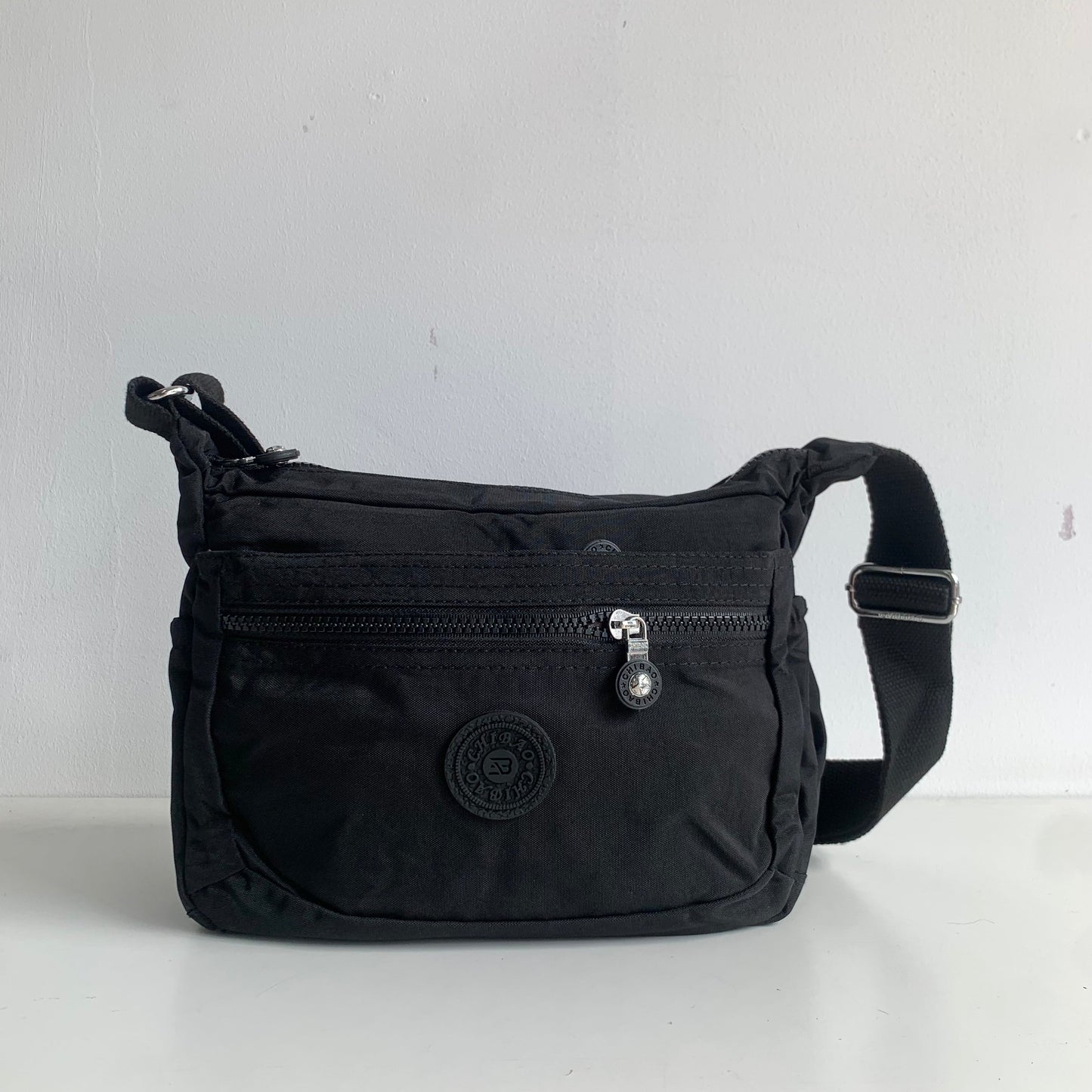 GESSY NYLON FRONT ZIP MULTI-LAYER CROSSBODY BAG IN BLACK