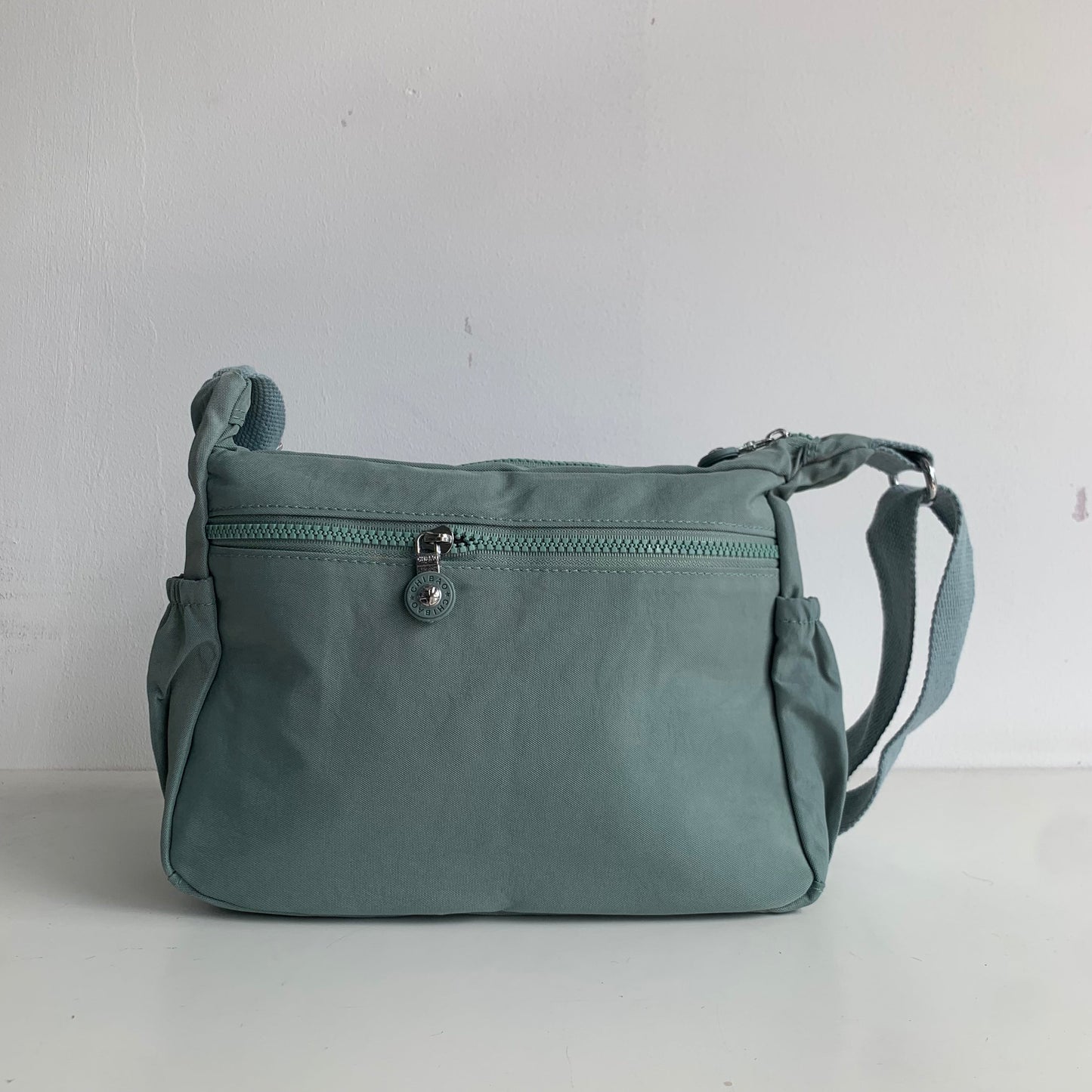 GESSY NYLON FRONT ZIP MULTI-LAYER CROSSBODY BAG IN GREEN