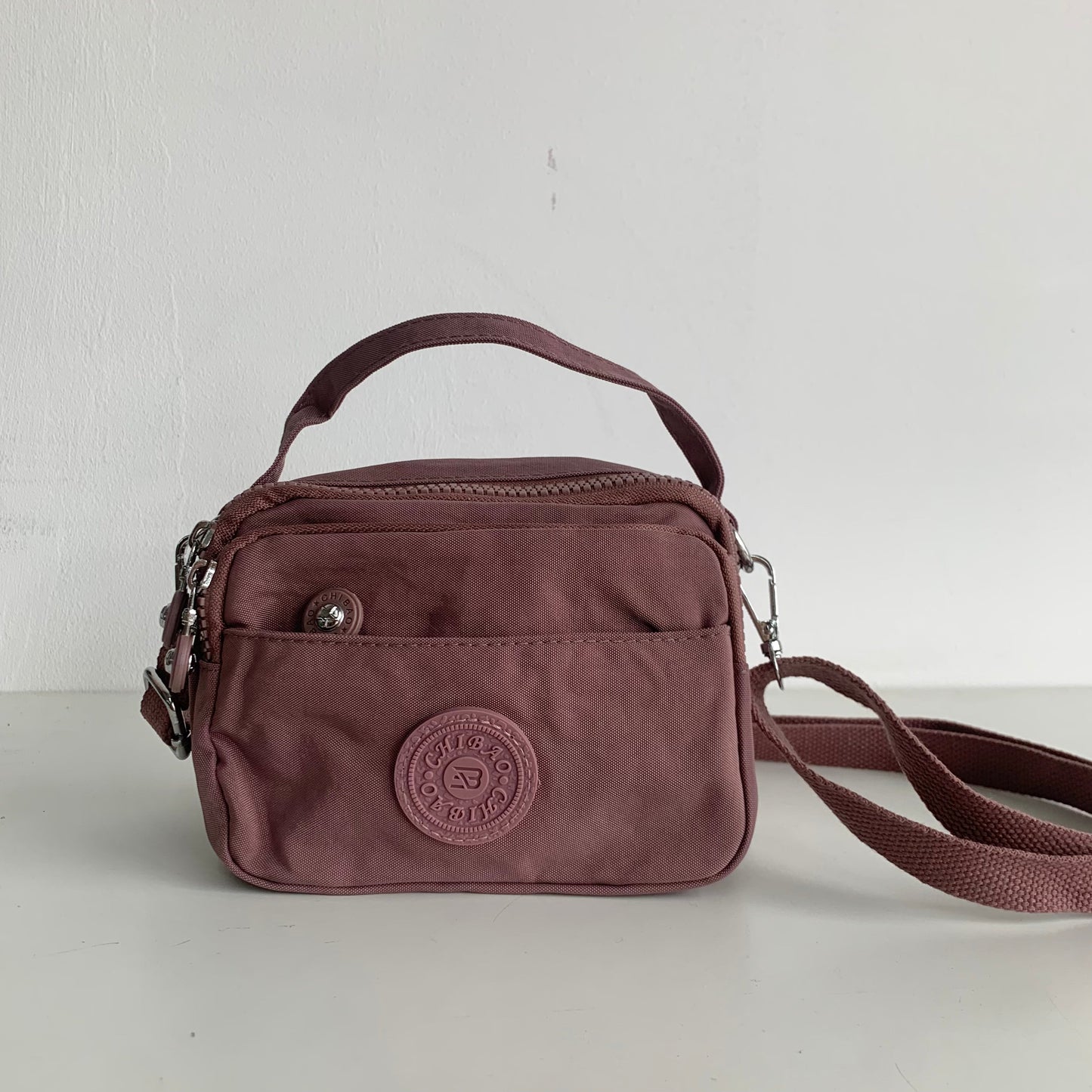 GESSY SMALL WATERPROOF UNISEX TOP HANDLE NYLON CROSSBODY BAG IN DARK PINK