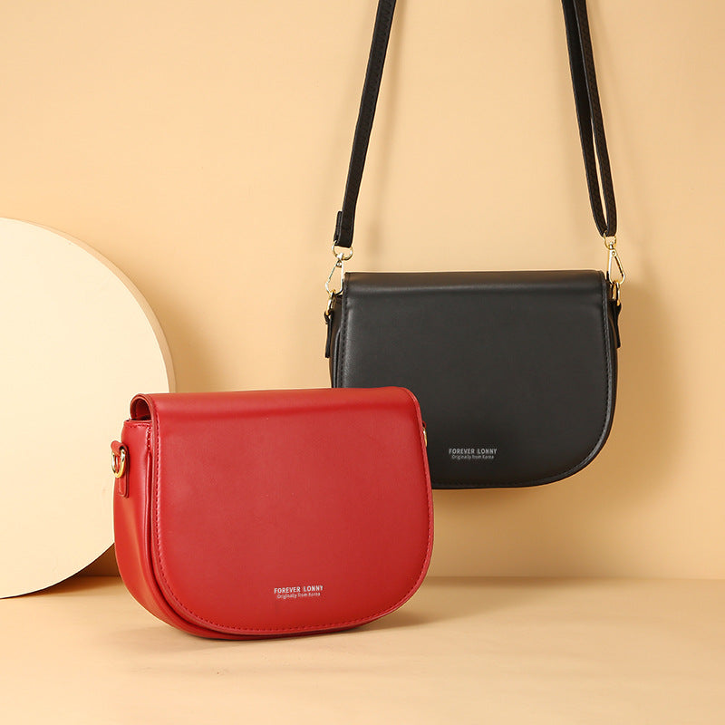 GESSY OVAL SHAPED CROSSBODY FLAP BAG IN BLACK