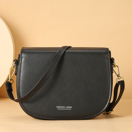 GESSY OVAL SHAPED CROSSBODY FLAP BAG IN BLACK
