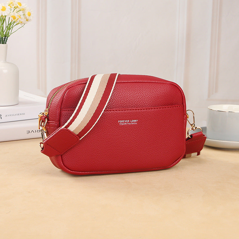 GESSY CROSSBODY BAG IN RED WITH STRIP PATTERNED STRAP