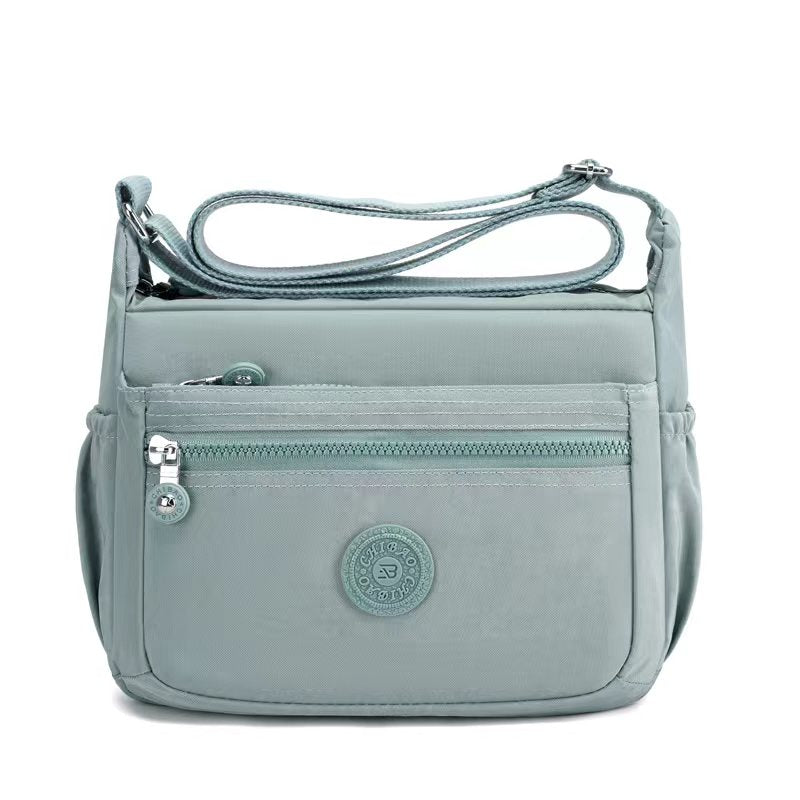 GESSY NYLON FRONT ZIP MULTI-LAYER CROSSBODY BAG IN GREEN