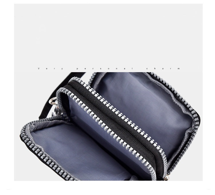 GESSY CROSS BODY PHONE BAG IN BLACK NAVY AND PINK