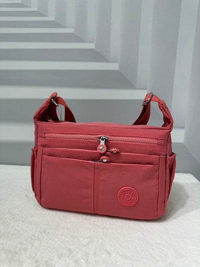 GESSY NYLON MULTIFUCTIONAL CROSSBODY BAG IN CORAL