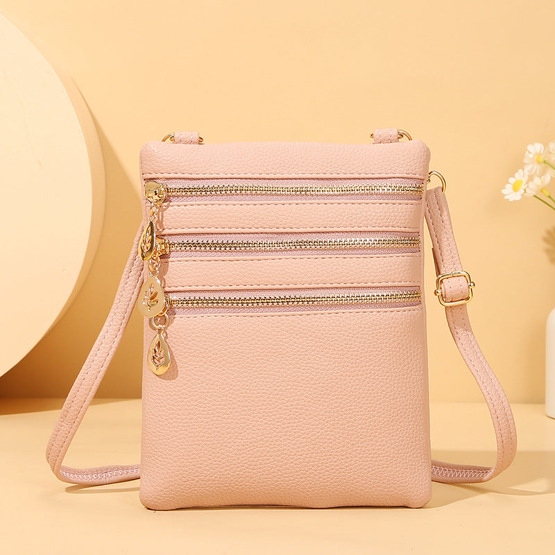 GESSY TRIPLE ZIP SMALL CROSSBODY BAG IN PINK